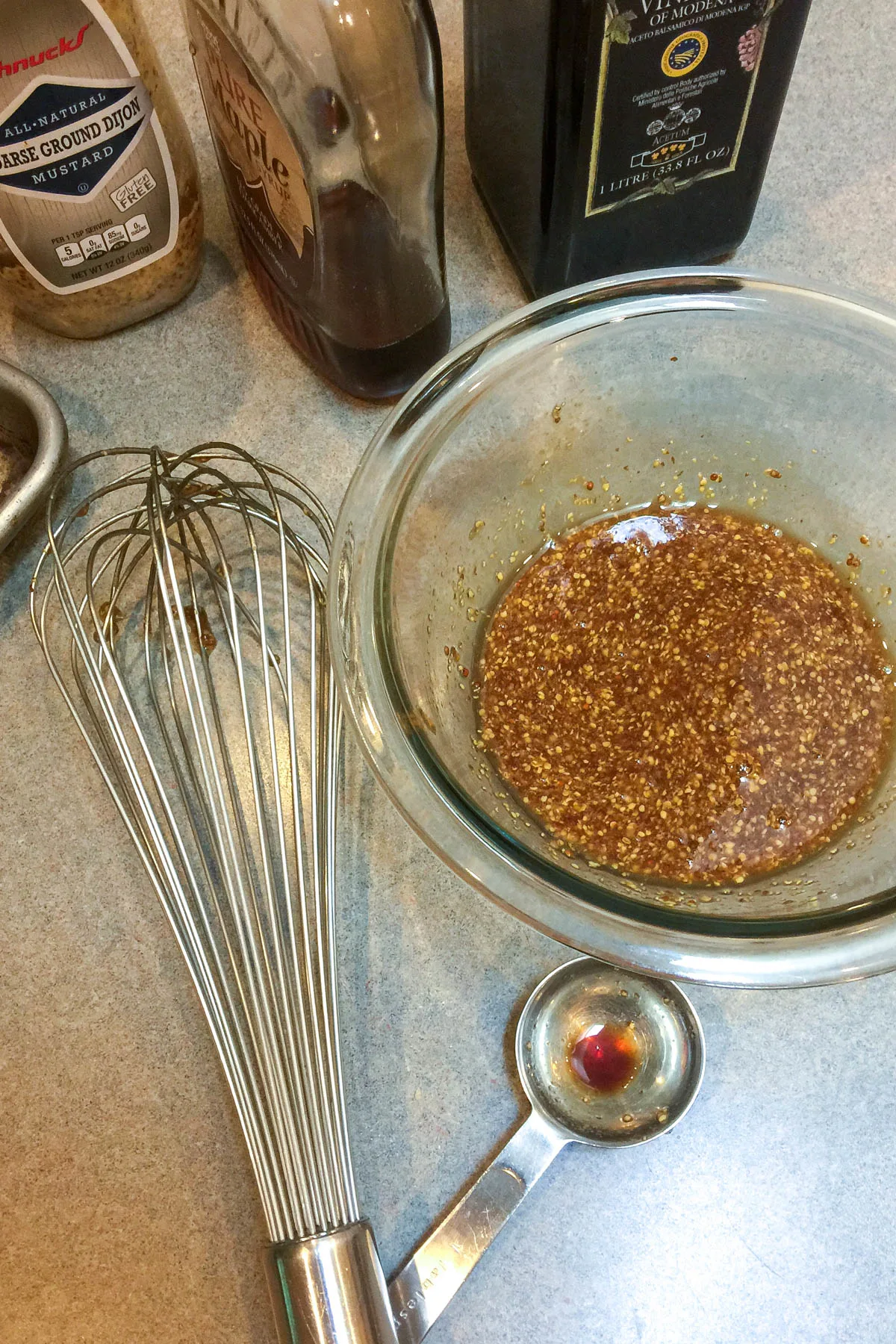 Whisking glaze ingredients in bowl.