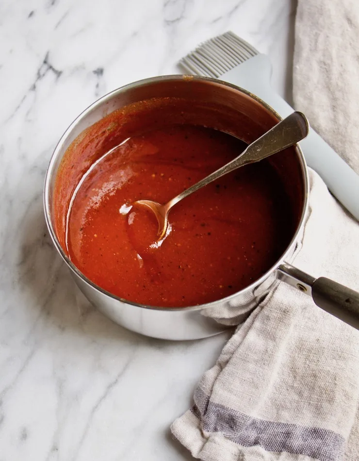 Homemade BBQ sauce in pan with brush.