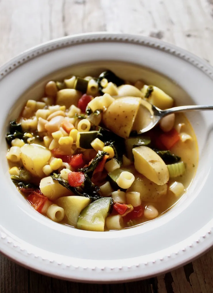 Summer minestrone in bowl with spoon
