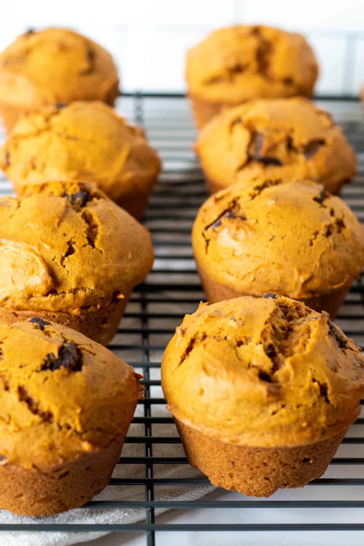 Muffins cooling on a rack.