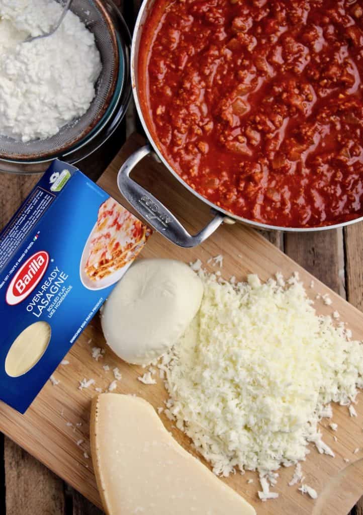 Ingredients ready to assemble, meat sauce, cottage cheese and shredded mozzarella