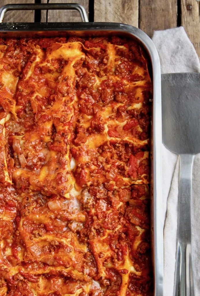 Mom's Lasagna, close up in pan, spatula on side, ready for serving