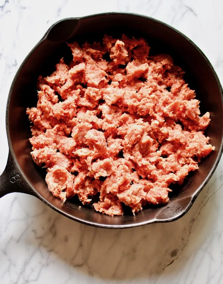 Sausage Gravy and Biscuits, raw breakfast sausage in skillet before browning