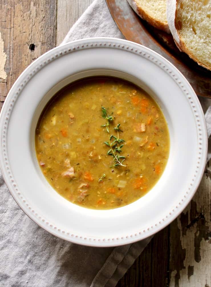 Split Pea and Lentil Soup in bowl with sprig of fresh thyme.