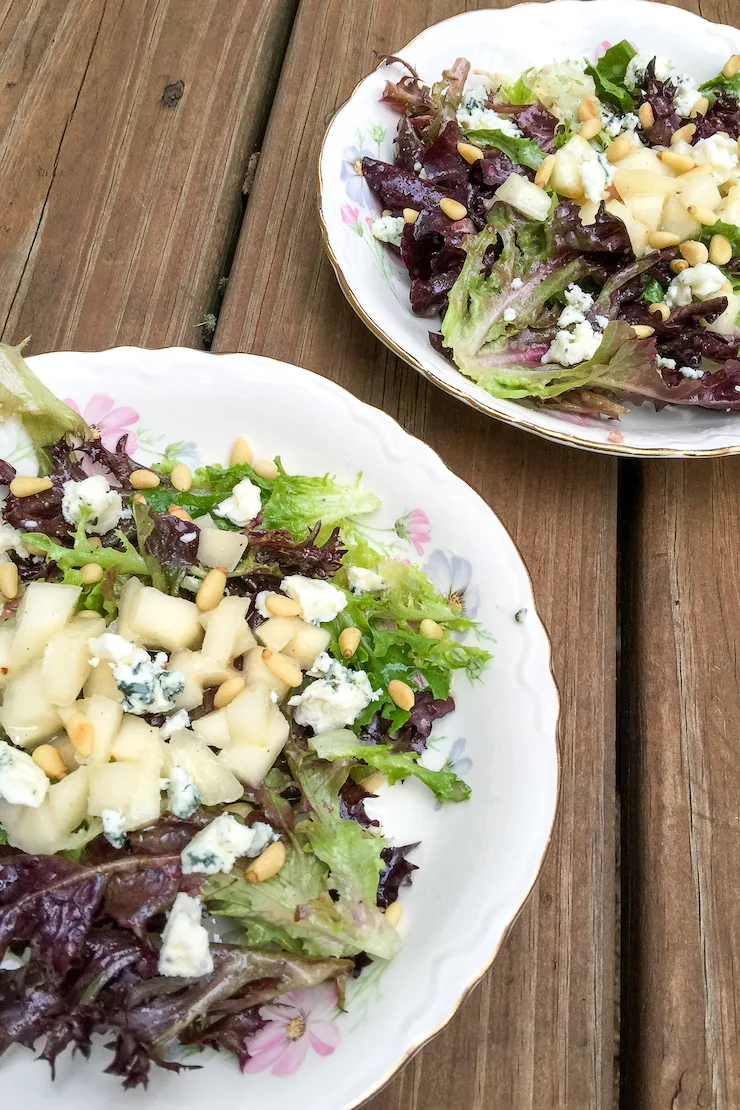 Pear and blue cheese salad on two salad plates.