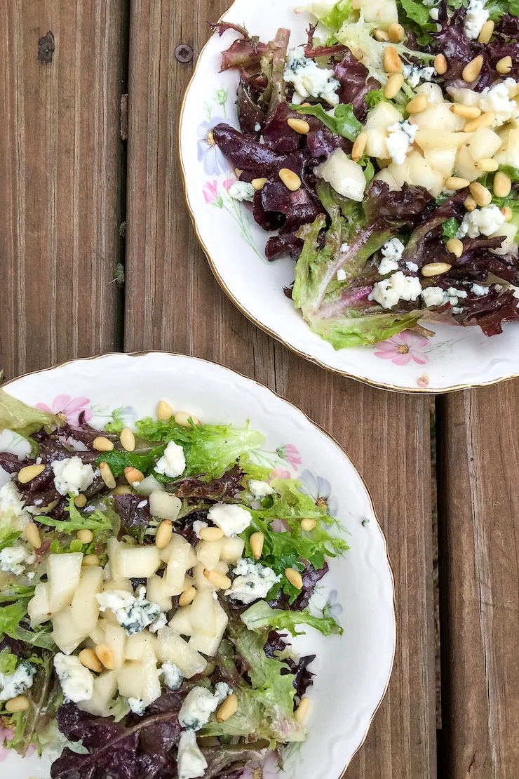 Plated salads on china plates.