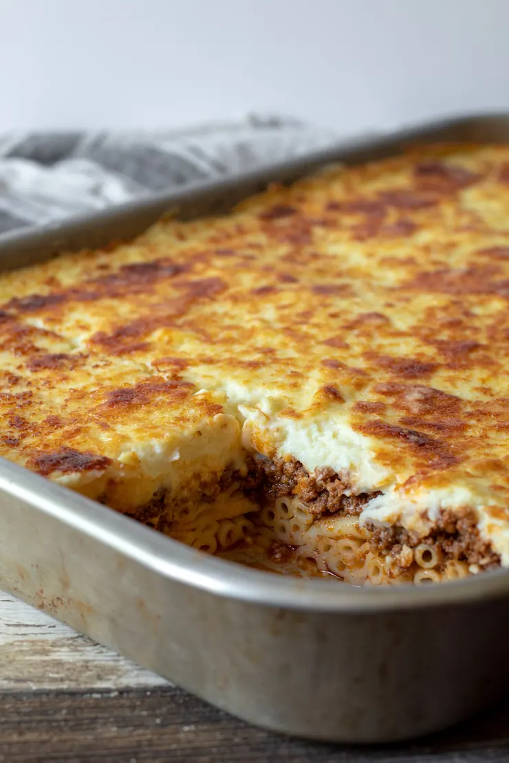 Baked pastitsio in pan showing layers.