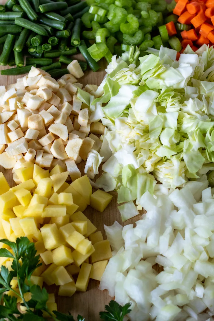 Cutting board filled with prepped and chopped vegetables.