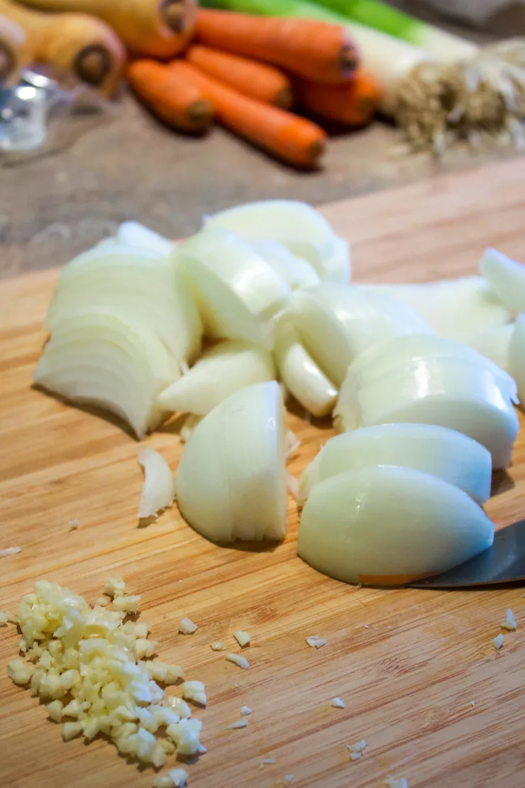 Onions prepped for stew, cut in wedges.