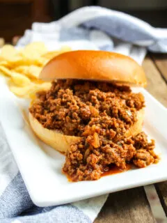 Sloppy Joe and chips on plate.
