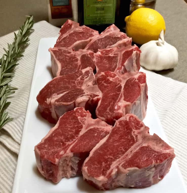 Loin lamb chops on platter before marinating.