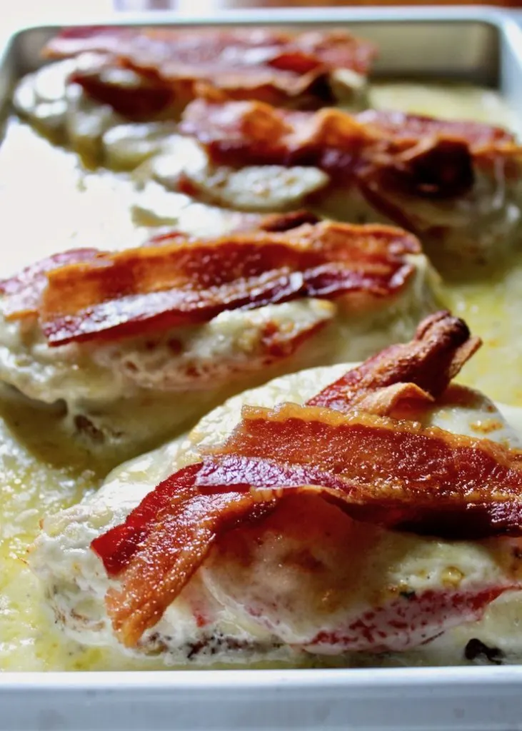 Close up of hot browns in pan with melted cheese.