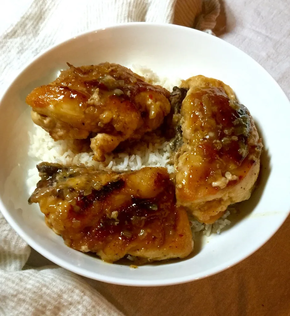 Finished glazed chicken plated with white rice.