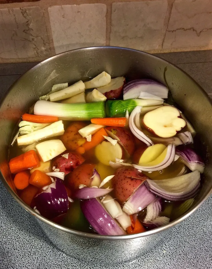 Corned Beef and Cabbage, vegetables cooking in corned beef broth on stove.