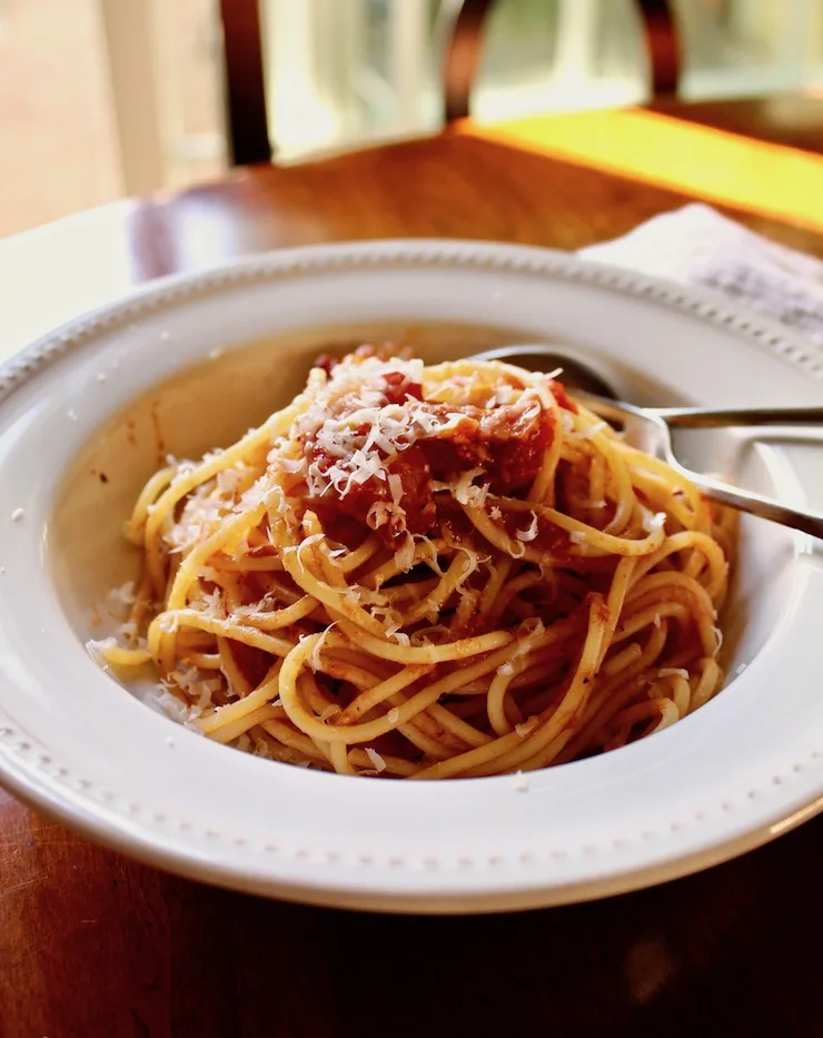 Spaghetti with Bacon Sauce, in bowl with spoon and fork.