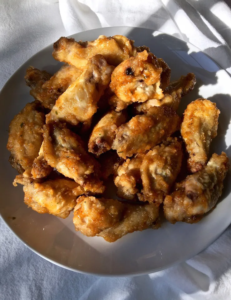 Hot Apricot Glazed Wings in white serving bowl.