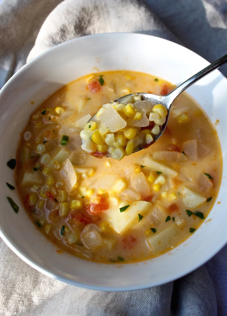 Summer Corn Chowder in a bowl with spoon.