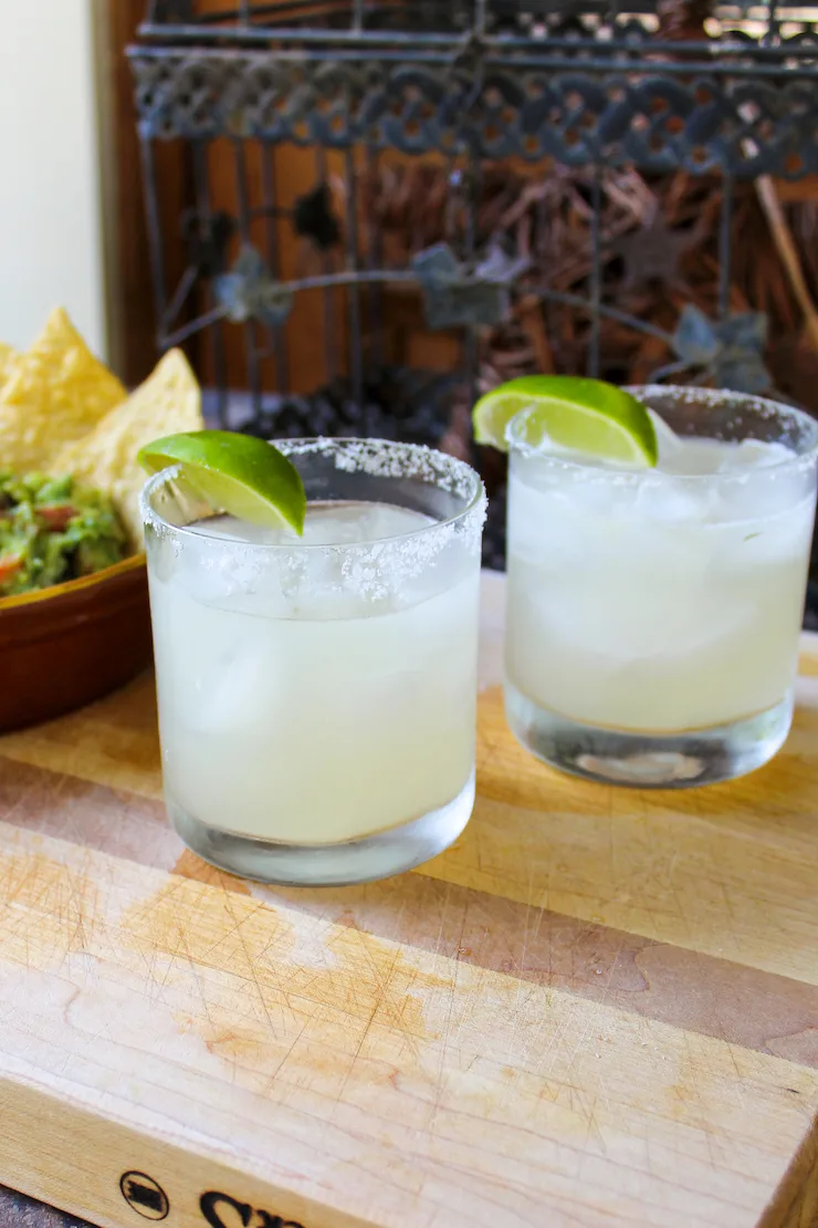 Two margaritas and guacamole and chips.