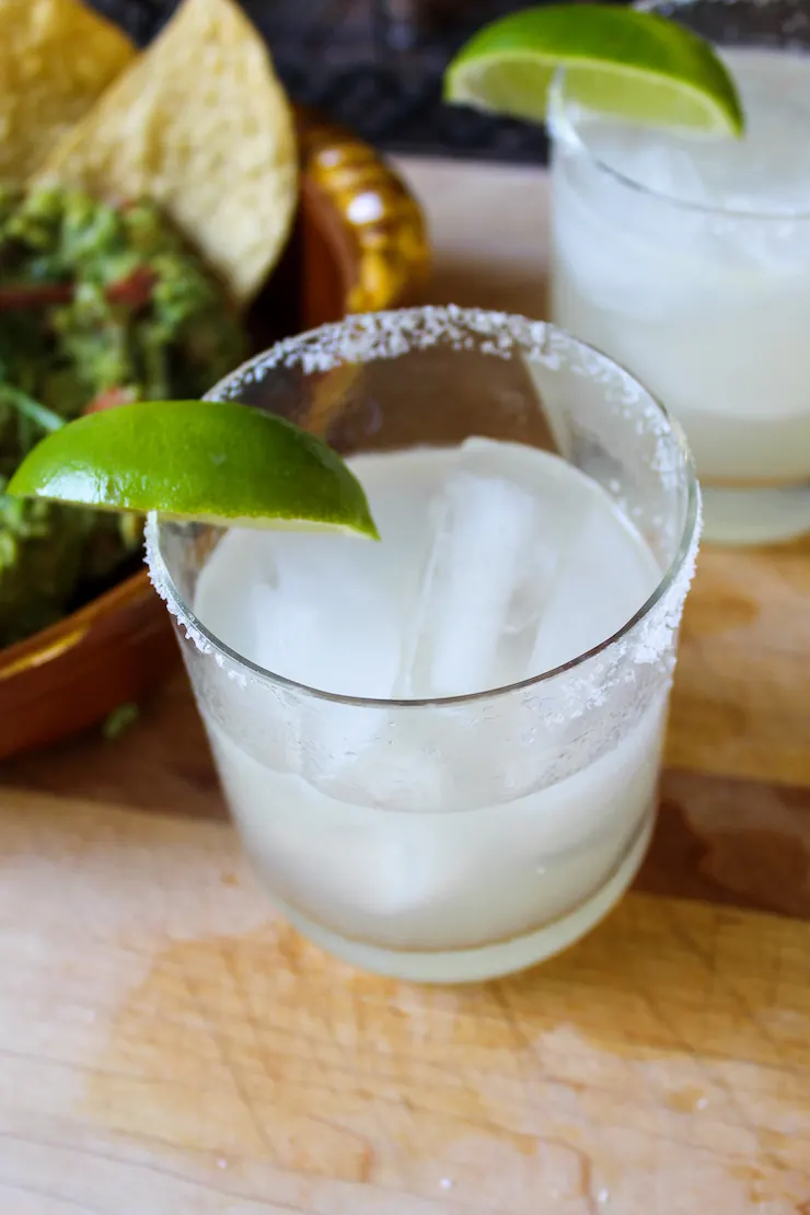Margarita in glass with lime wedge and salted rim.