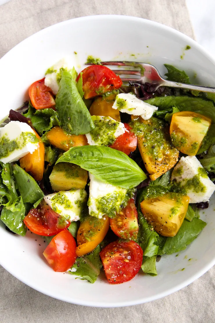 Caprese salad in white bowl.