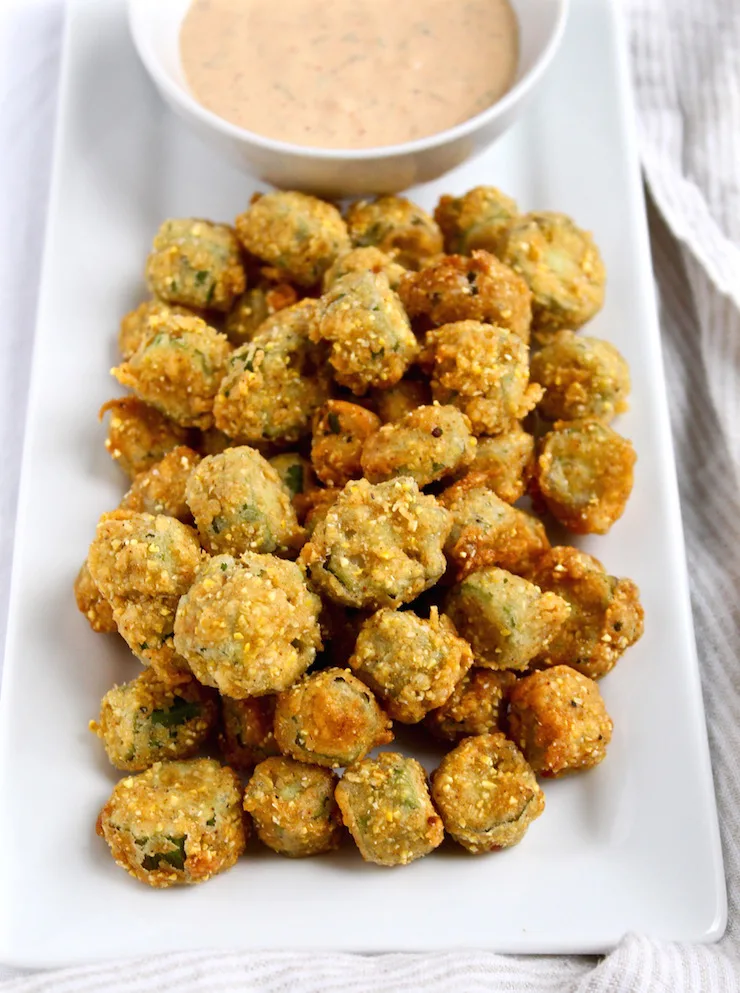 Fried Okra with Louisiana Rémoulade sauce on white platter.