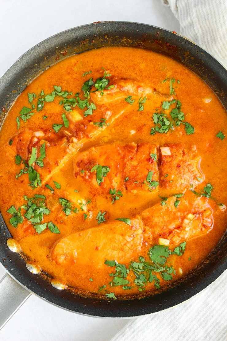 Coconut curry salmon in skillet.