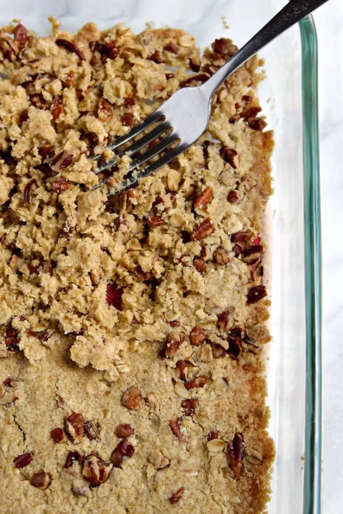 Crumbling the baked dough with a fork.