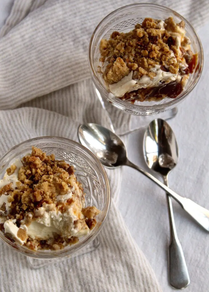 Overhead of ice cream dessert in serving dishes and spoons.