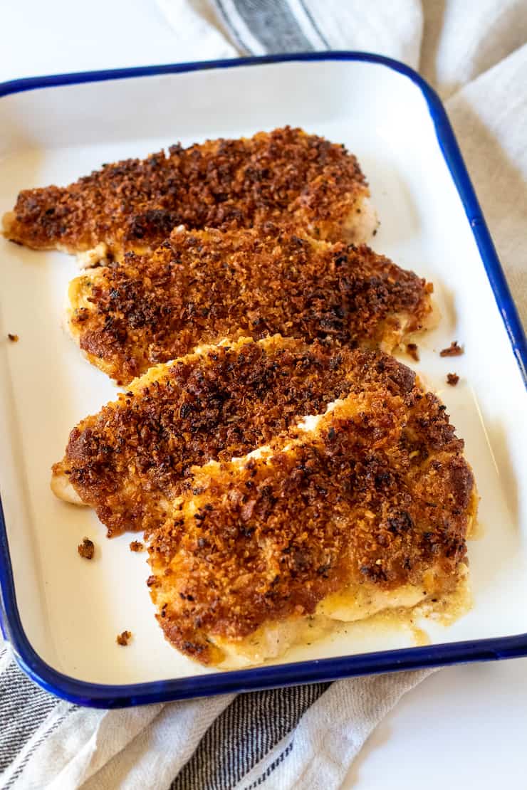 Onion Parmesan Chicken breasts in serving dish.