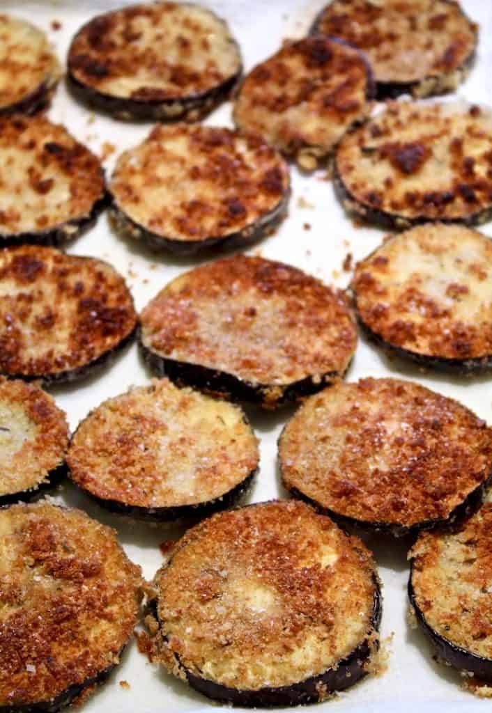 Fried eggplant slices draining on paper towels