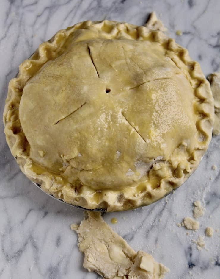 Pie crust brushed with egg wash before baking.