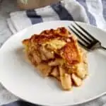 Slice of apple pie on plate.
