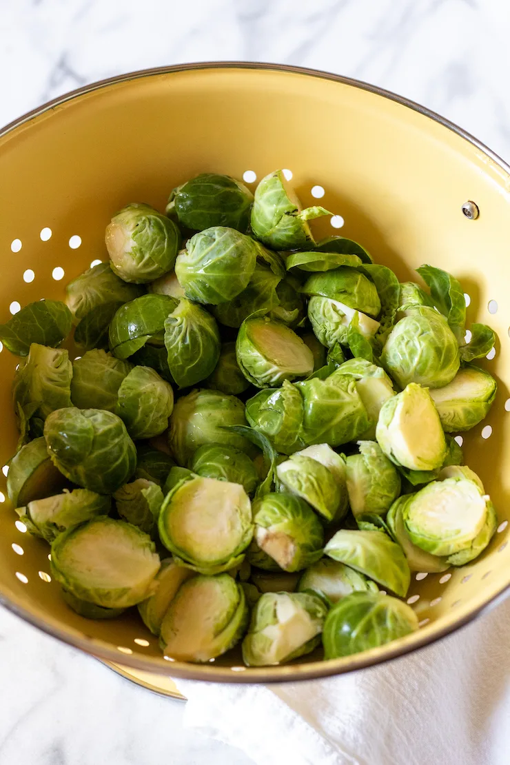 Brussels sprouts trimmed and cleaned in colander.