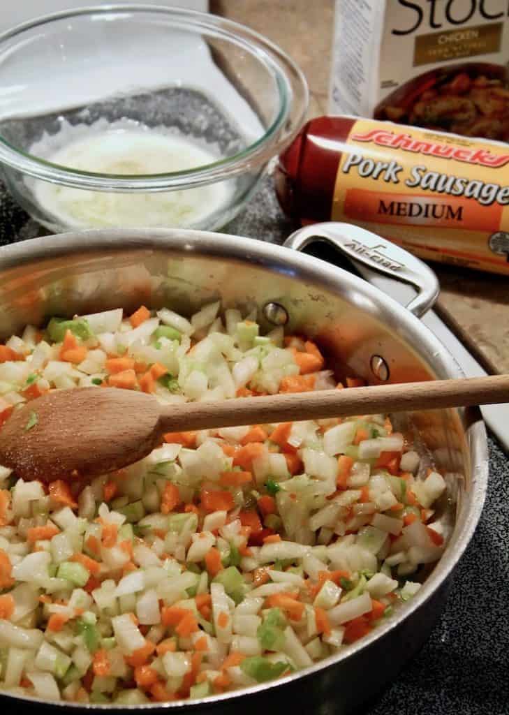 Chopped vegetables cooking in skillet.