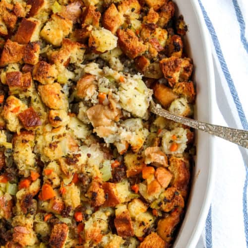 Stuffing in serving dish with spoon.