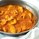 Side view of chicken paprikash in pan.