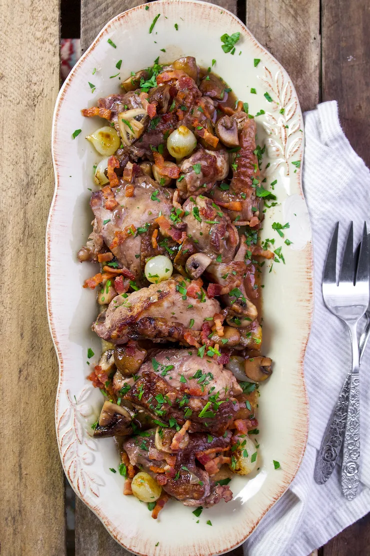 Coq au vin on serving platter.