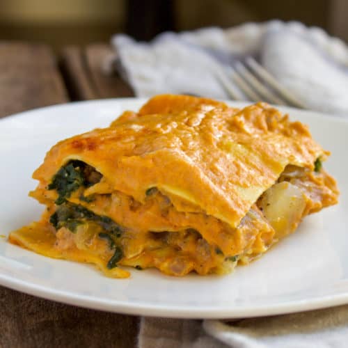 Piece of pumpkin lasagna on white plate.