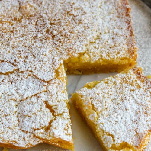 Lemon Squares, on board with corner piece cut.