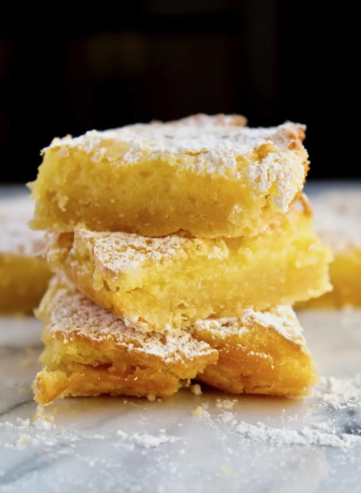Lemon Squares, three bars stacked on marble board.
