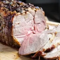 Close up of medium rare roasted boneless leg of lamb.