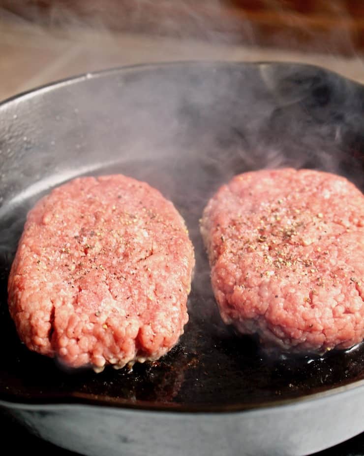 Diner-Style Patty Melts, two beef patties cooking in skillet