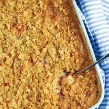 King ranch casserole in baking dish with spoon.