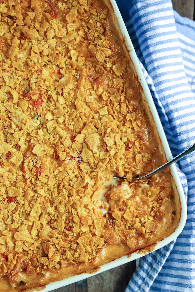 King ranch casserole in baking dish with spoon.