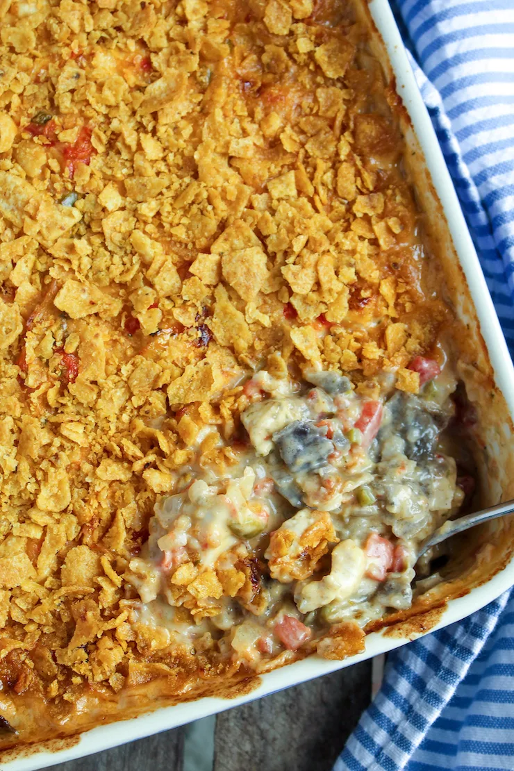 Overhead view of baked casserole with corner spoonful.