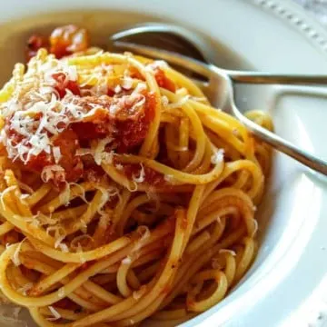 Plated in serving bowl with grated cheese.