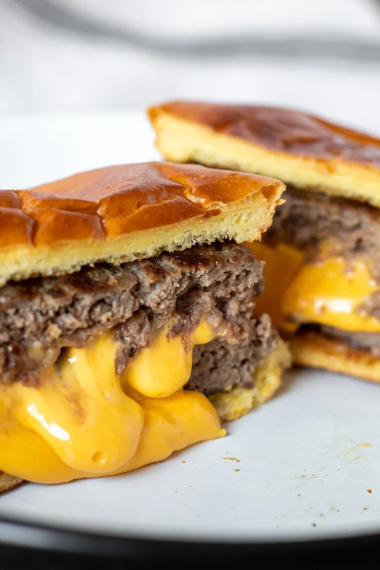 Burger cut in half with molten cheese center.