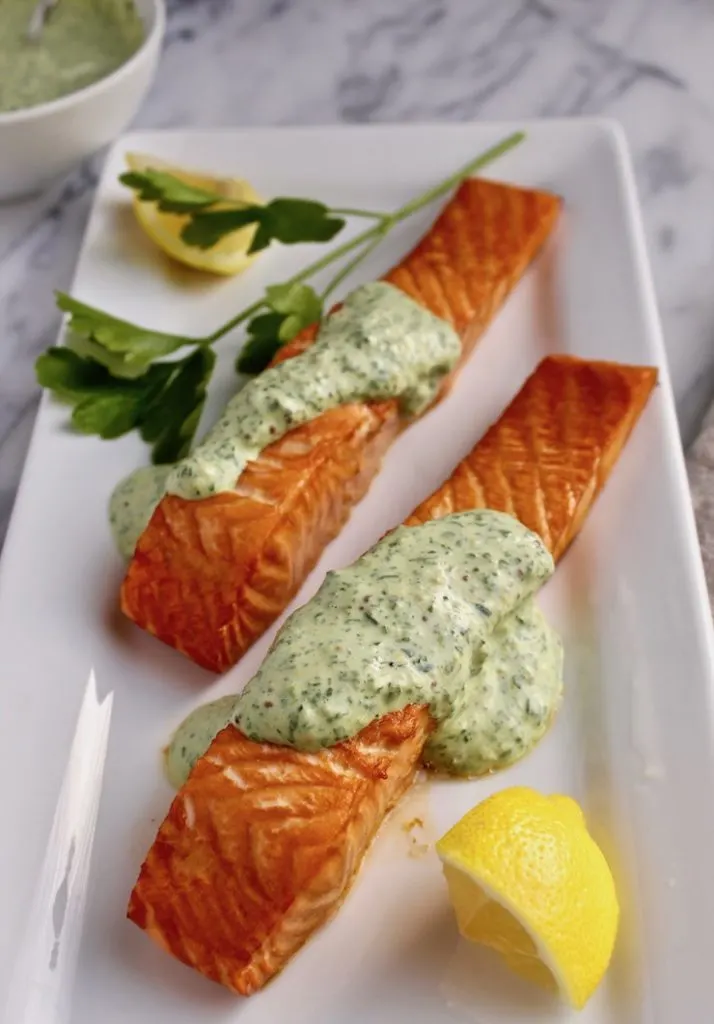 Roasted Salmon with 'Greens' Mustard Sauce on serving platter with lemon