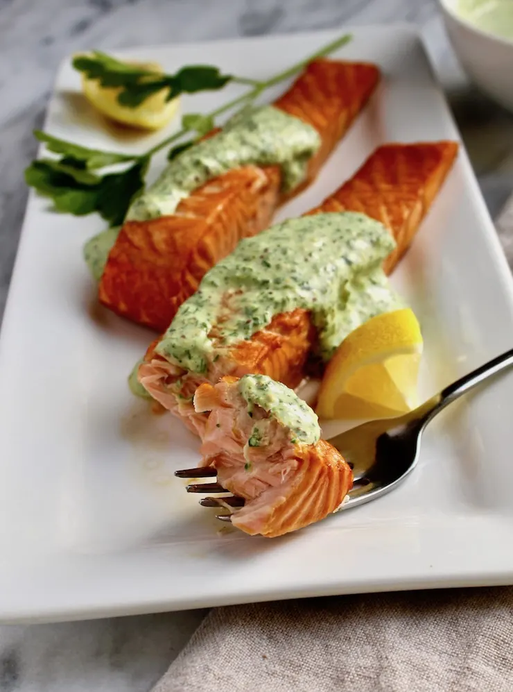Roasted Salmon with 'Greens' Mustard Sauce, on platter with fork full of salmon.