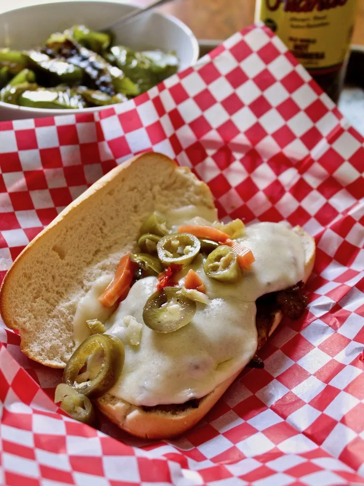 Italian Beef Po' Boys, sandwich with melted cheese and hot peppers.